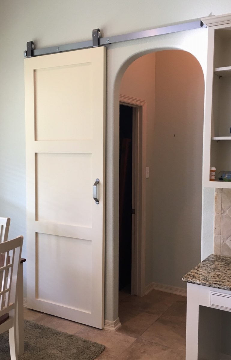 White sliding barn door covering bedroom doorway 